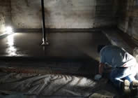 worker pouring concrete floor