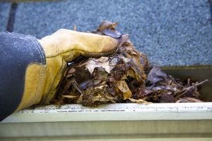 cleaning clogged roof gutters